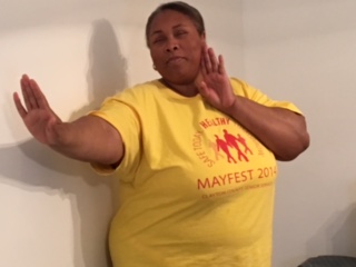 Empish demonstrating a self defense pose with her hands near her sholders